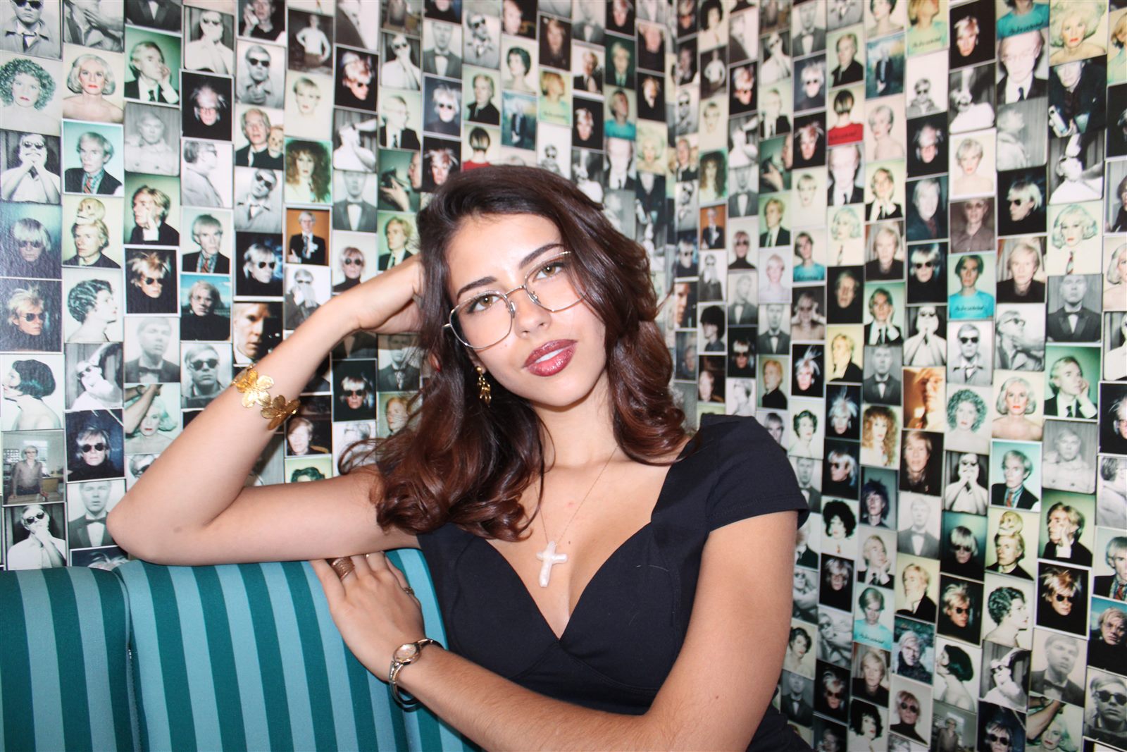 A woman in glasses resting her head on her hand